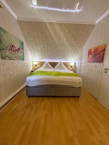 a bedroom with a bed in a room at Pension Cao Lai in Varel