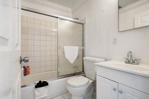 a bathroom with a shower and a toilet and a sink at Stunning 2BR with Ocean, Mountain & Sunset Views in Pacifica