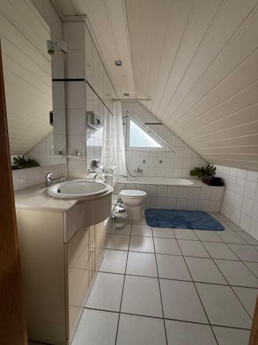 a bathroom with a sink and a toilet at Pension Cao Lai in Varel