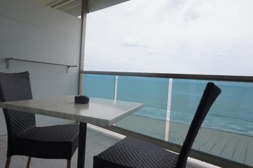 a table and two chairs in front of a window at Hotel Columbus in Lignano Sabbiadoro
