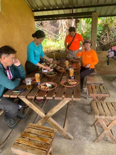 a group of people sitting around a picnic table at Royal Mountain Edge ,Knuckles in Rangala