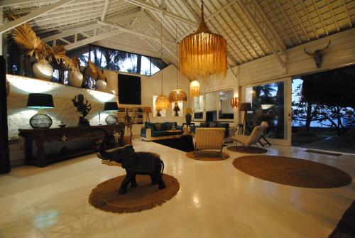 a living room with a statue of a bear on the floor at Beach Villa Pantai Matanai in Tianyar