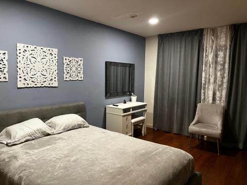 a bedroom with a bed and a desk and a television at Spacious Home Steps from Huge Park and Outdoor Fun in San Jose