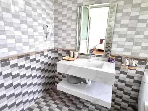 a bathroom with a sink and a mirror at Top Hill Halong in Ha Long