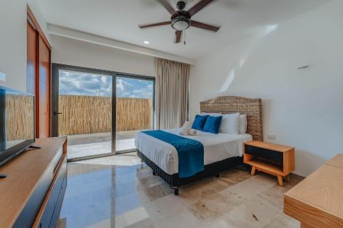 a bedroom with a bed and a large window at Departamento con vista al mar . in Telchac Puerto