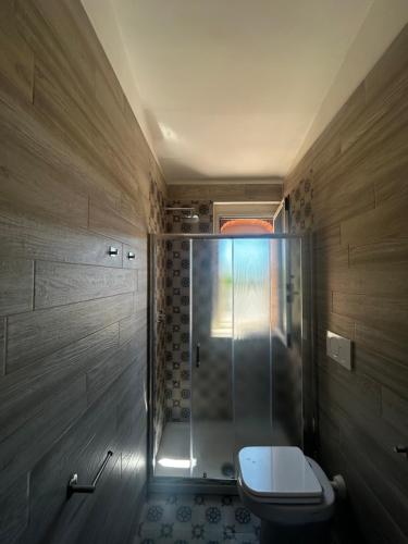 a bathroom with a toilet and a glass shower at Villa Monte Sacro - Manfredi Homes& Villas in Mattinata