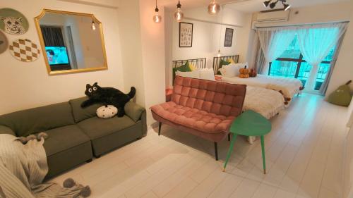 a living room with a couch and a bed at Stunning luxury APT with balcony in Tokyo Shinjuku Kabukicho in Tokyo