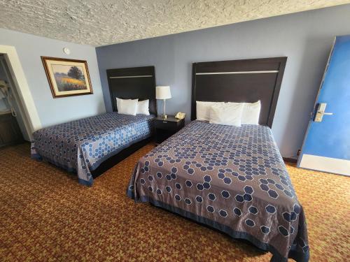 a hotel room with two beds in a room at Carthage Inn in Carthage