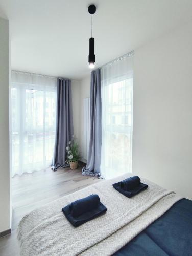 a bedroom with a bed with two pillows on it at Toscany de LUX samo centrum in Bielsko-Biała