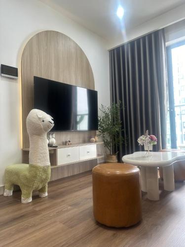 a living room with a tv and a stuffed animal at Châu Giang Homestay, Nera Garden Huế in Thôn Văn Dương