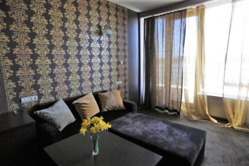 a living room with a couch and a table at Hotel Neptun in Vidin