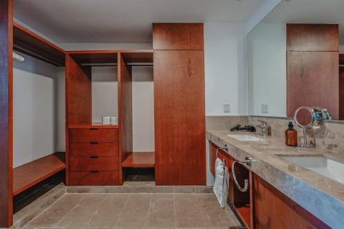 a kitchen with wooden cabinets and a sink at Departamento con vista al mar . in Telchac Puerto