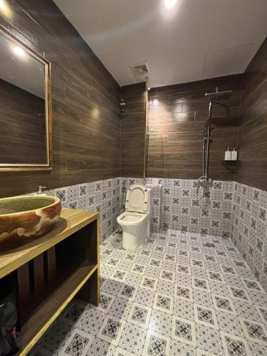 a bathroom with a toilet and a sink at An Thuong House - Hoan Kiem, Hanoi Center in Hanoi