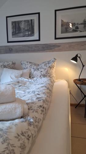 a bed with white sheets and pillows on it at Weberhof-Münster 2 in Münster