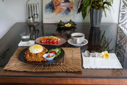a table with two plates of food on a table at Eiwa House in Ubud
