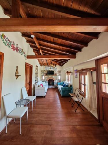 a living room with wooden ceilings and a fireplace at Villa Hera Doğanbey in Doğanbey