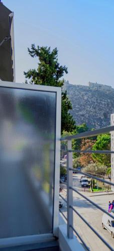 a view of a city street from a balcony at marietta city center apartments Nafplio in Nafplio