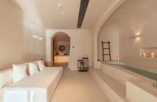 a living room with a white couch and a swimming pool at 大理松云悬崖酒店 in Dali Ancient Town