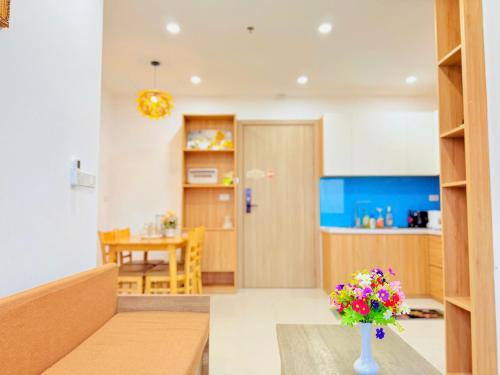 a living room with a vase of flowers on a table at Châu Giang Homestay, Nera Garden Huế in Thôn Văn Dương