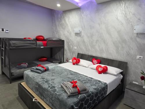 a bedroom with a bed with red bows on it at B&B la marica in Adrano