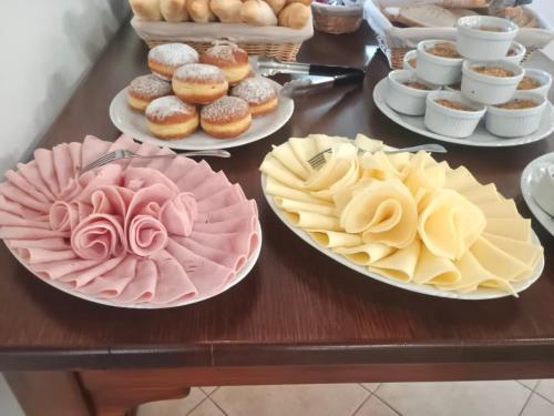 a table topped with plates of pastries and donuts at Resort U Jelena in Křivoklát