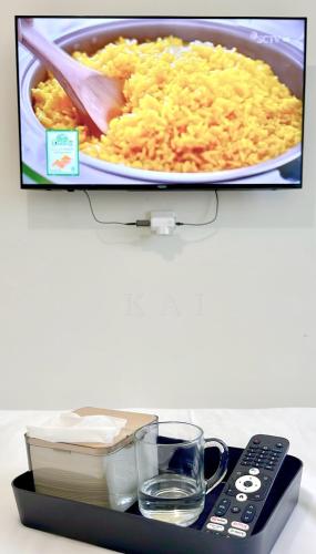 a picture of a plate of rice and a remote control at Pollux Habibie Lvl 52 Sea View Studio with Gym,Pool & Netflix in Batam Center