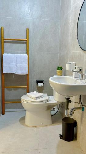 a bathroom with a toilet and a sink at Pollux Habibie Lvl 52 Sea View Studio with Gym,Pool & Netflix in Batam Center