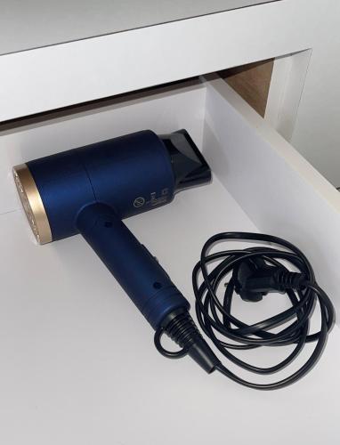 a blue flashlight sitting on top of a white desk at Pollux Habibie Lvl 52 Sea View Studio with Gym,Pool & Netflix in Batam Center