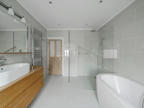 a white bathroom with a tub and a sink at Stunning 3BR Townhouse - Central Oxford Pass the Keys in Oxford