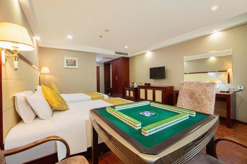 a hotel room with a pool table on a couch at GreenTree Inn Taiyuan PinGYAng Road Business Hotel in Taiyuan