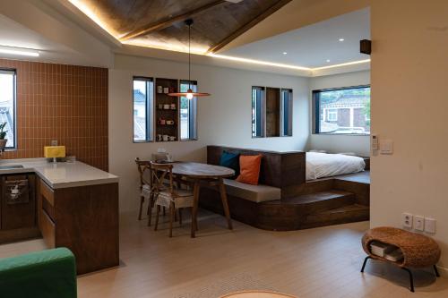 a bedroom with a bed and a table in a room at Cocoa House in Jeonju