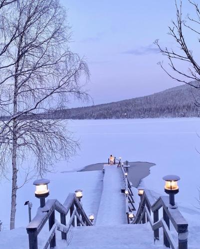 a dock on a lake with lights on it at Lapland Tunturimaja Ski in, sauna, wifi, in Pyhä center - Lapland Villas in Pyhätunturi