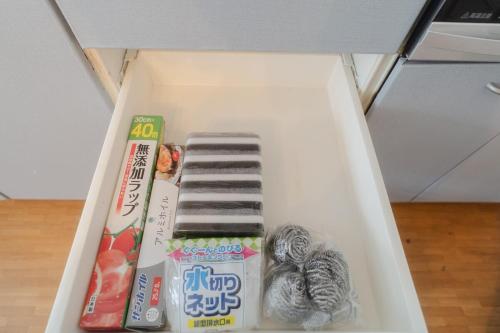 a white drawer with some items in it at TIDA Ishigaki in Ishigaki Island