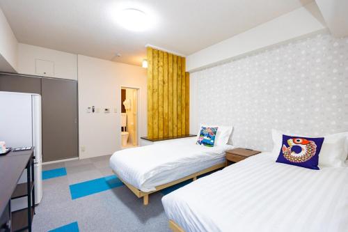 a hotel room with two beds and a television at ksi南常盤台301 in Tokyo