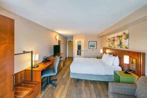 a hotel room with a bed and a desk at Comfort Inn in Charlottetown
