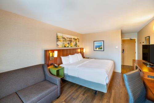 a hotel room with a large bed and a couch at Comfort Inn in Charlottetown