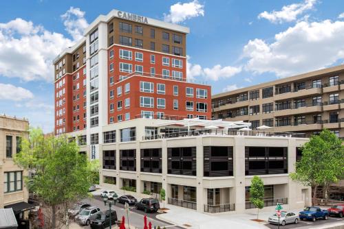 a tall building with cars parked in a parking lot at Cambria Hotel Downtown Asheville in Asheville