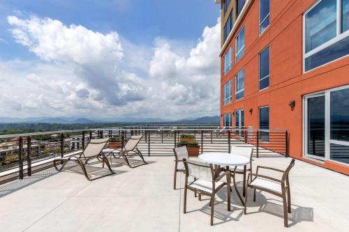 a patio with chairs and a table on a building at Cambria Hotel Downtown Asheville in Asheville