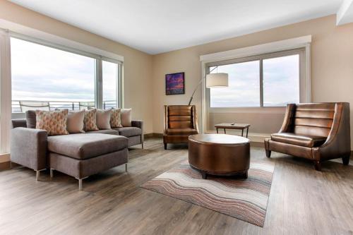 a living room with a couch and two chairs at Cambria Hotel Downtown Asheville in Asheville