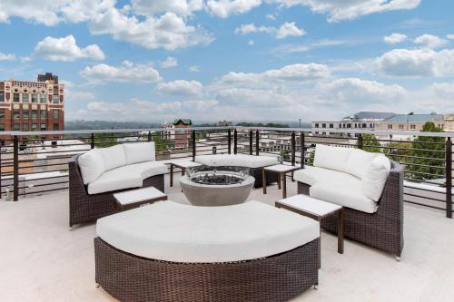 a patio with chairs and tables on a balcony at Cambria Hotel Downtown Asheville in Asheville