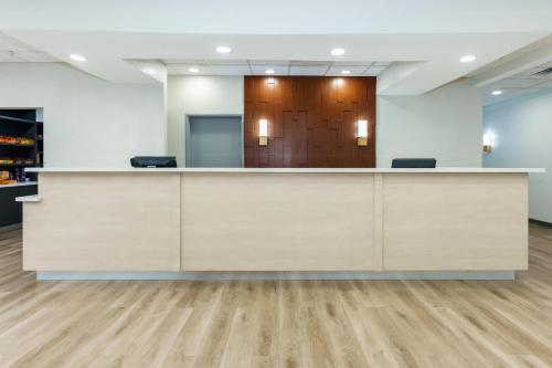 an empty office with a reception desk in a room at Comfort Suites University Drive in College Station
