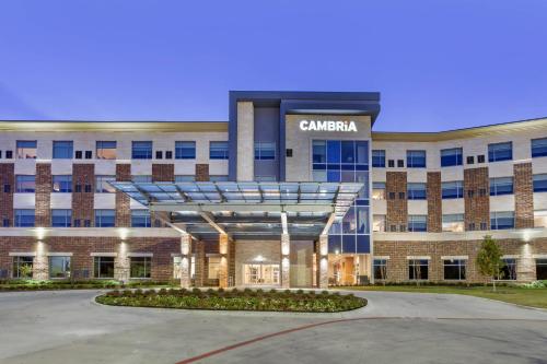 a building with a sign on the front of it at Cambria Hotel Plano - Richardson Garland in Richardson