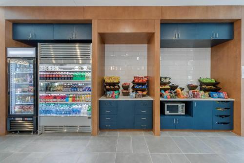 a store with blue cabinets and a refrigerator at Cambria Hotel Mount Pleasant - Charleston in Charleston
