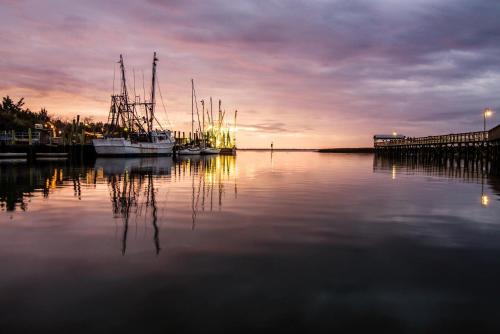 a group of boats docked at a dock at sunset at Cambria Hotel Mount Pleasant - Charleston in Charleston