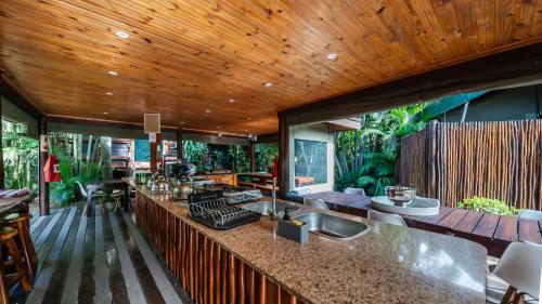 an open kitchen with a counter top and a wooden ceiling at Luxury Tented Village @ Urban Glamping in St Lucia