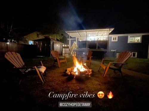 a fire pit in a yard at night at Cozy Private Suite with HOT TUB fire pit and AC! in Hope