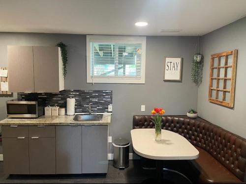 a kitchen with a counter and a table and a counter top at Cozy Private Suite with HOT TUB fire pit and AC! in Hope