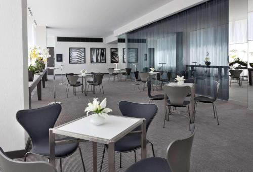 a dining room with tables and chairs and tablesktop at Radisson Blu Aqua Hotel, Chicago in Chicago