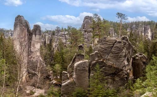 a group of rock formations in the woods at Chatka na břehu rybníka Pupek in Kohoutov