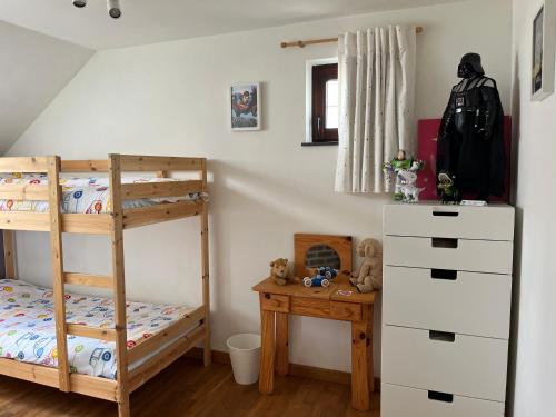a bedroom with two bunk beds and a desk at Les Scailletons à Neufchâteau - Ardenne Belge in Neufchâteau